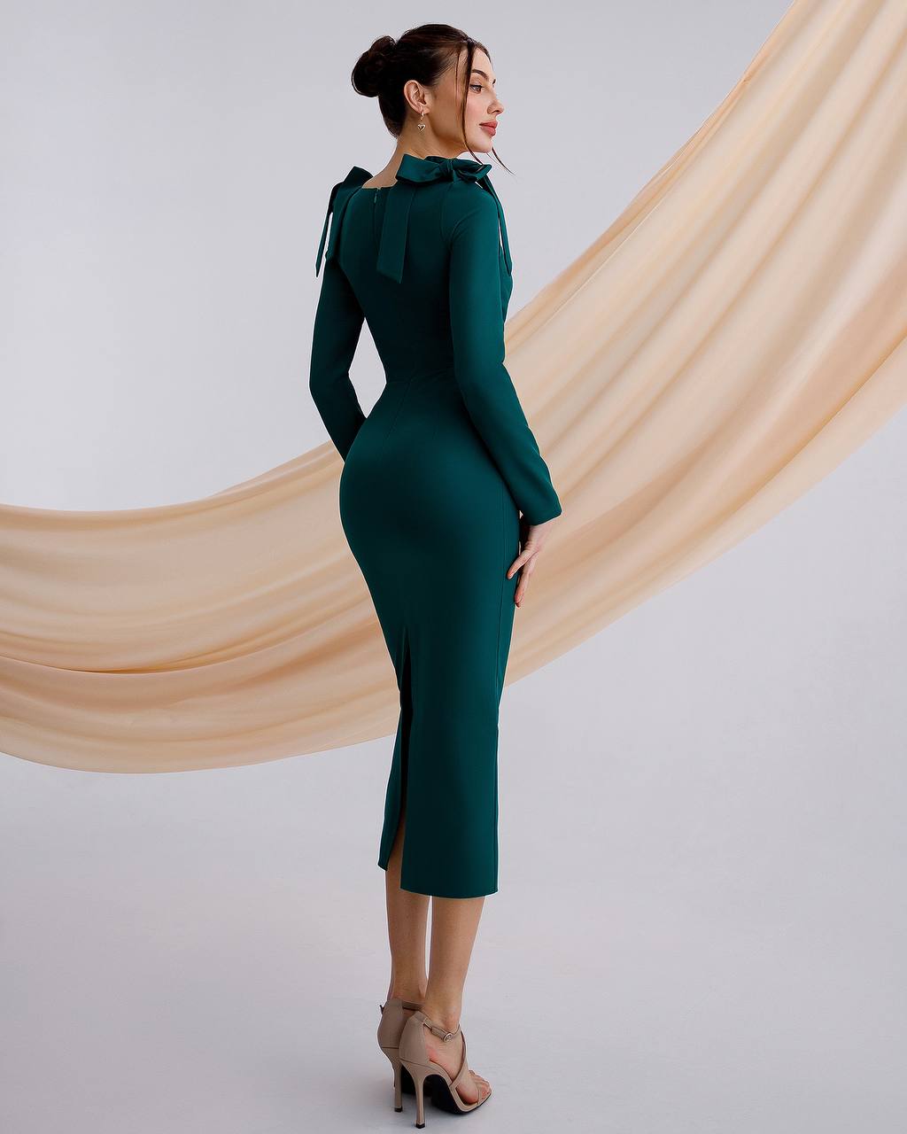 a woman in a green dress with a high neck
