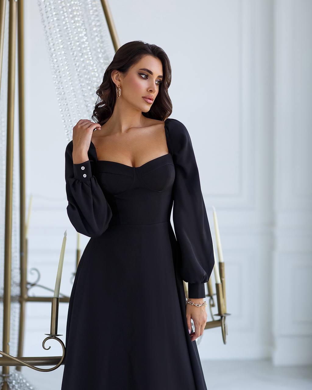 a woman in a black dress posing for a picture