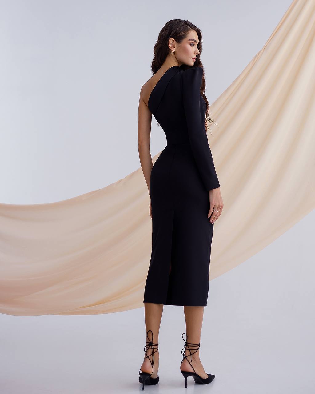 a woman wearing a black dress with a high neck