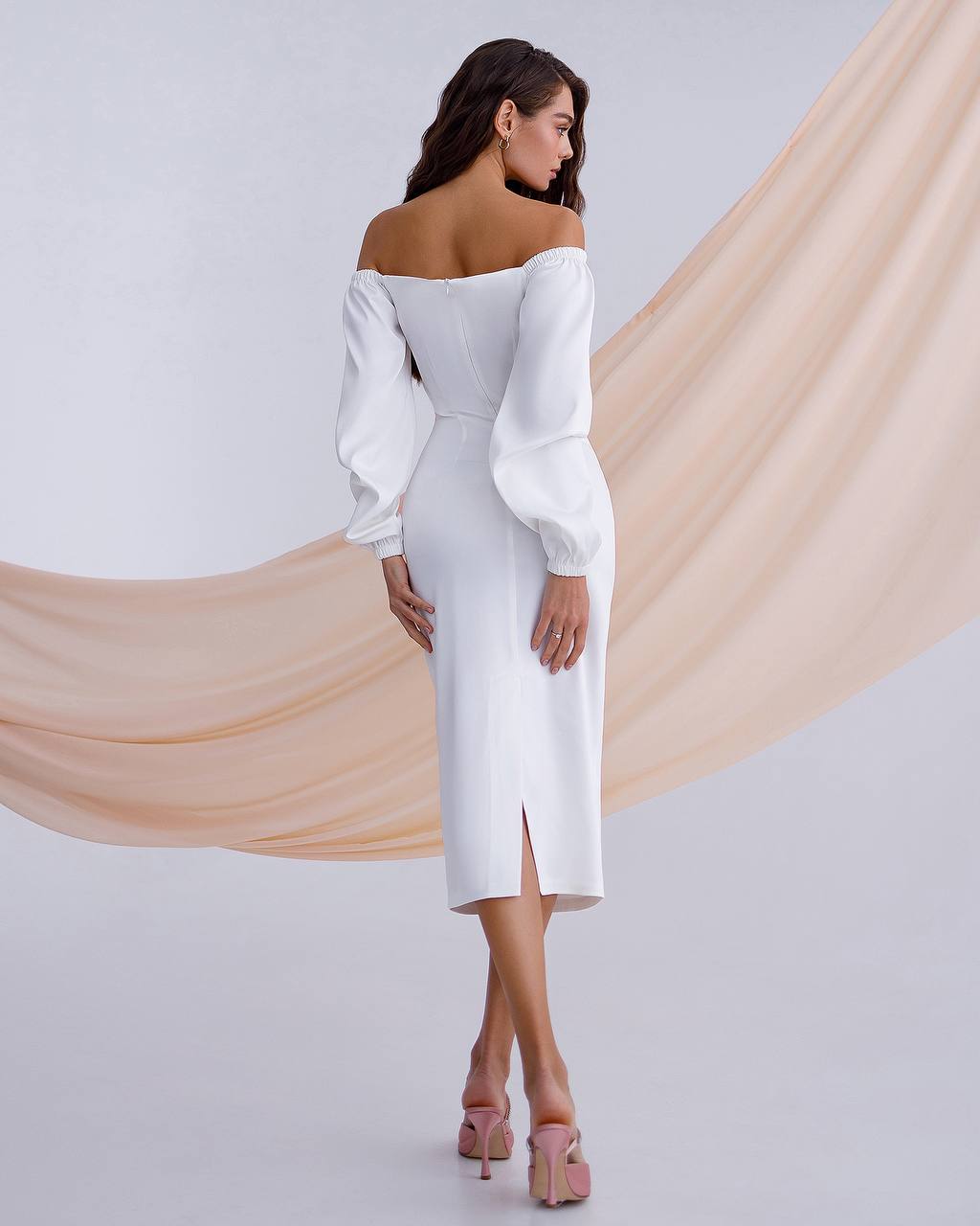 a woman wearing a white dress with a slit
