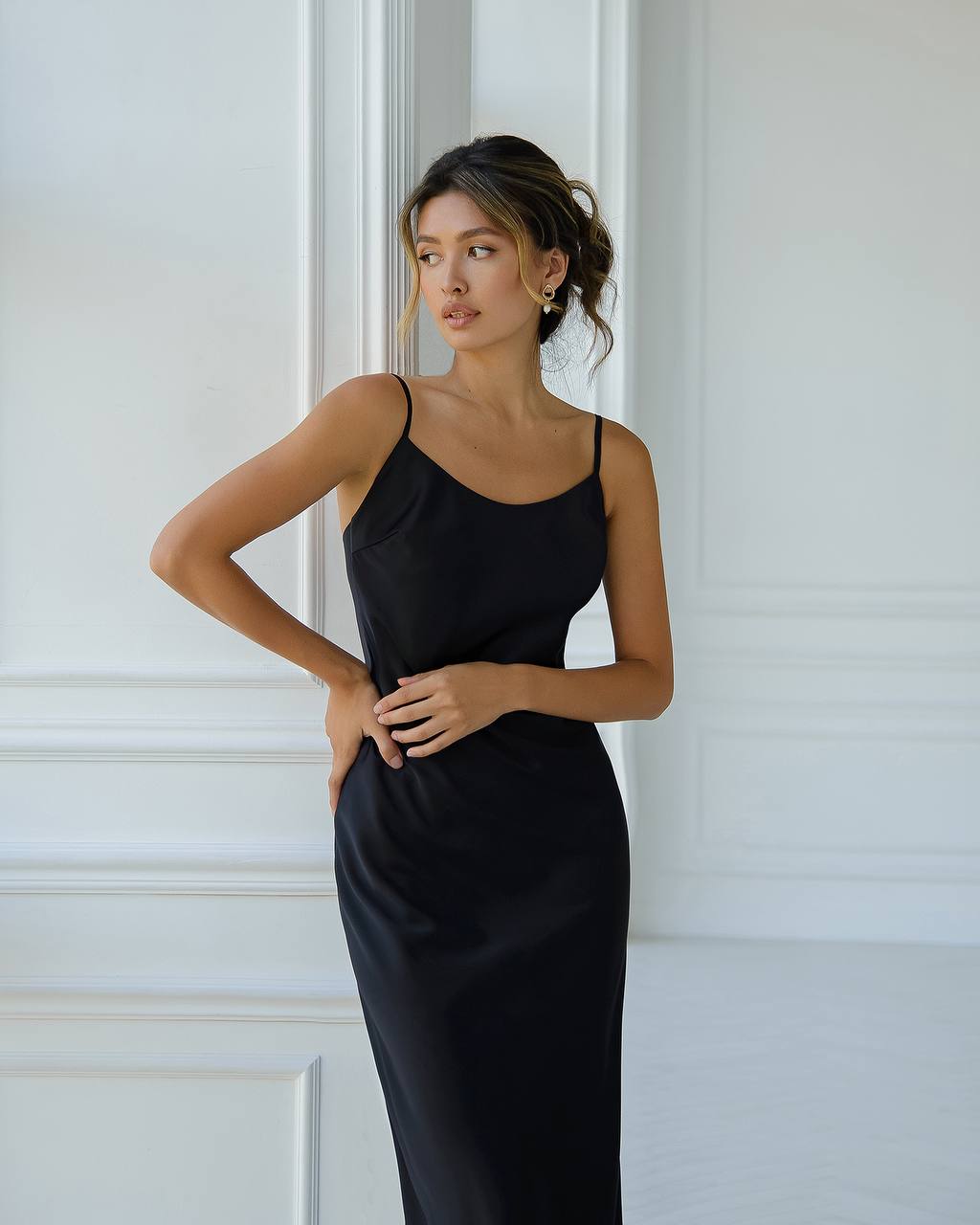 a woman in a black dress posing for a picture