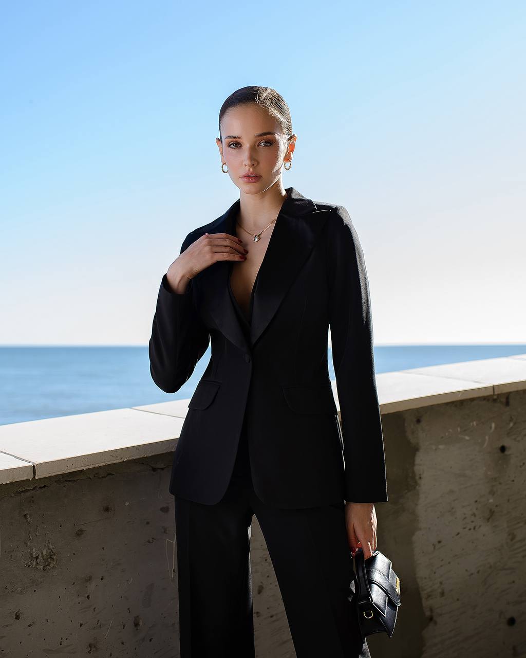 a woman in a black suit posing for a picture