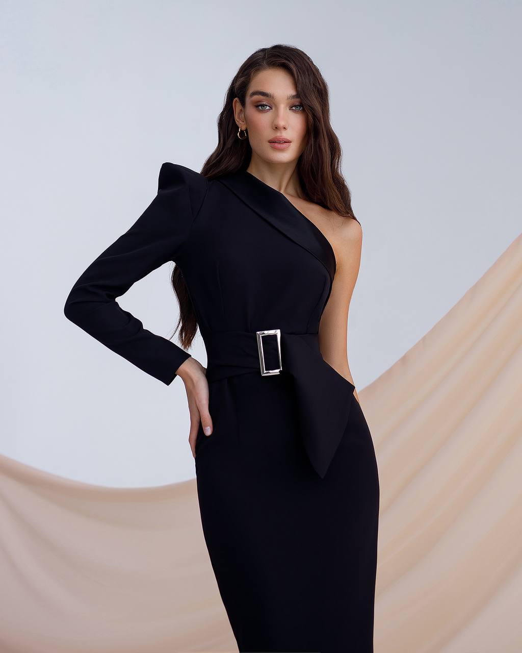 a woman in a black dress posing for a picture