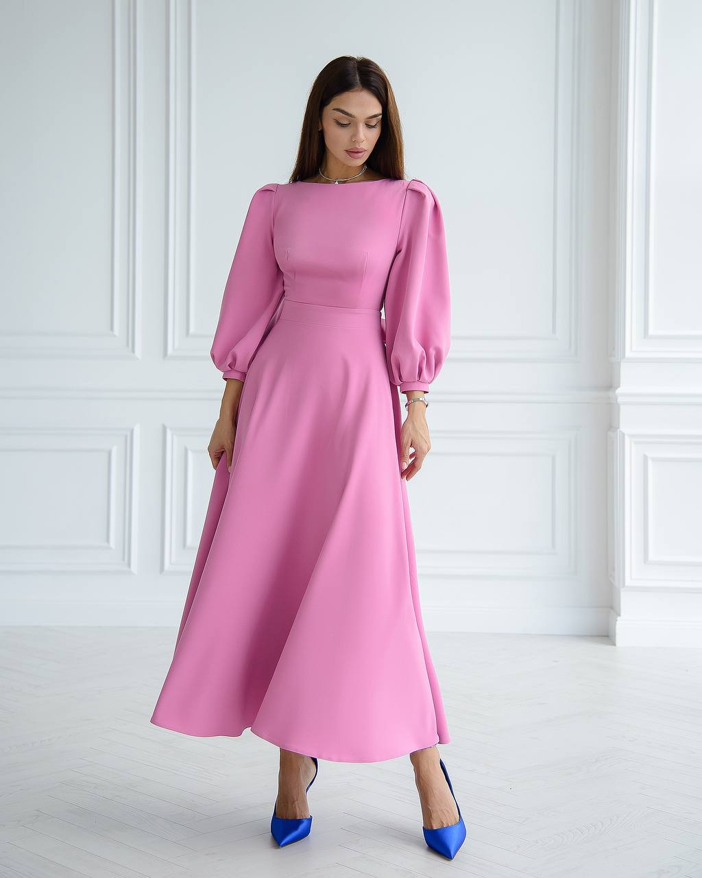 a woman wearing a pink dress and blue shoes