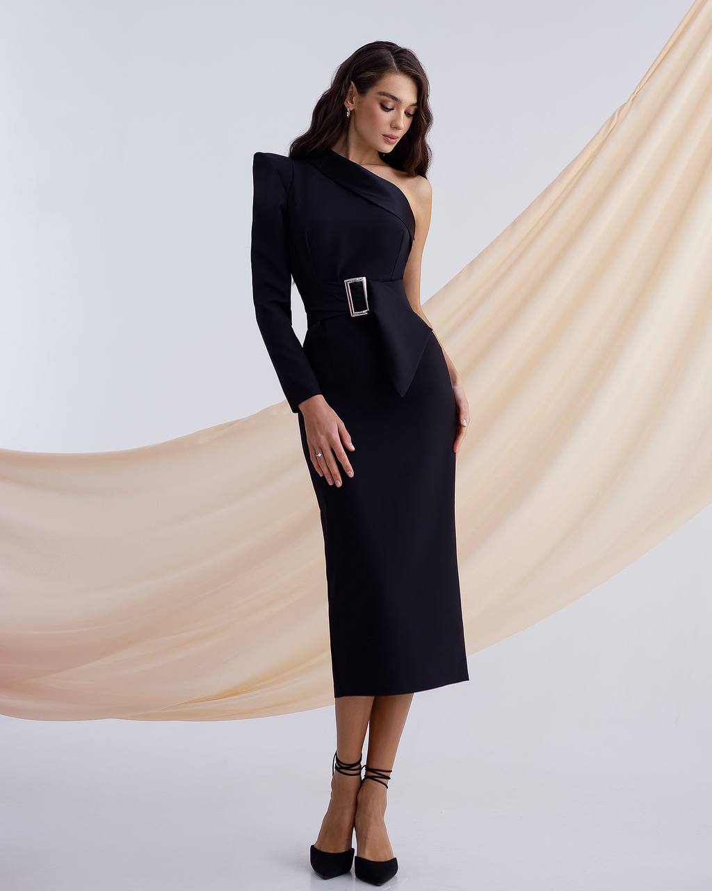 a woman wearing a black dress with a one shoulder