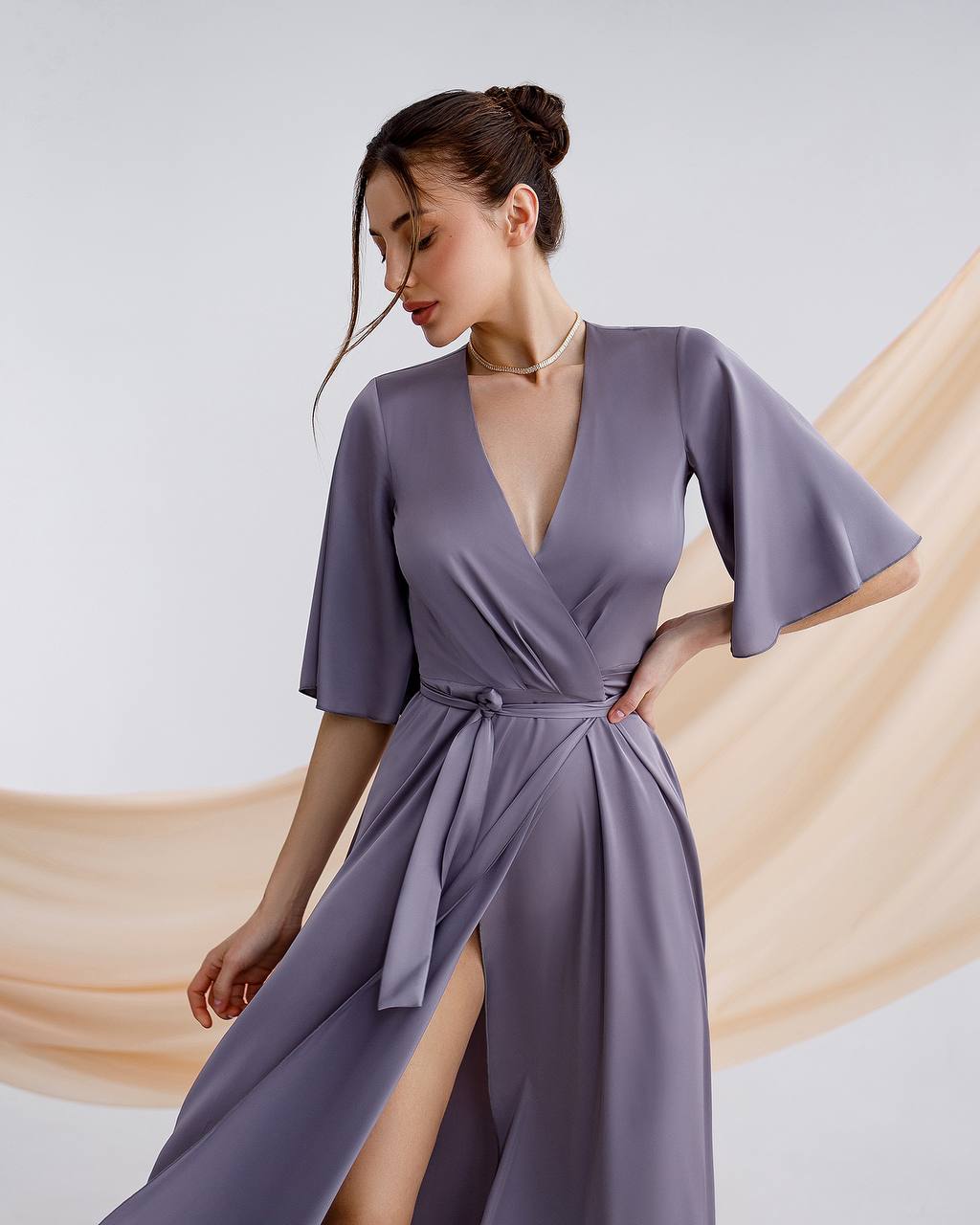 a woman in a purple dress with a slit