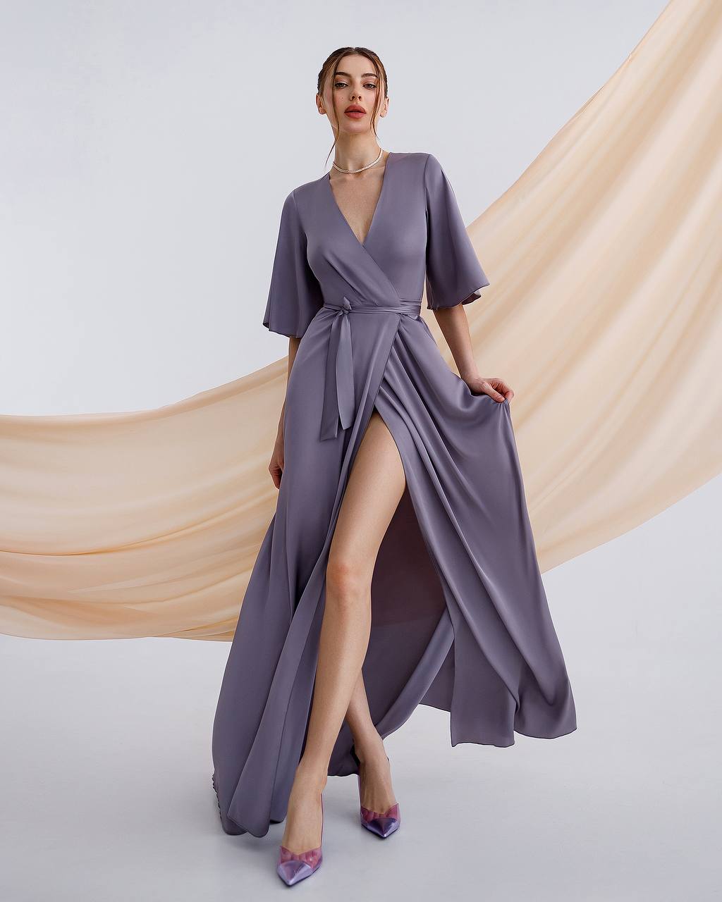 a woman in a purple dress posing for a picture