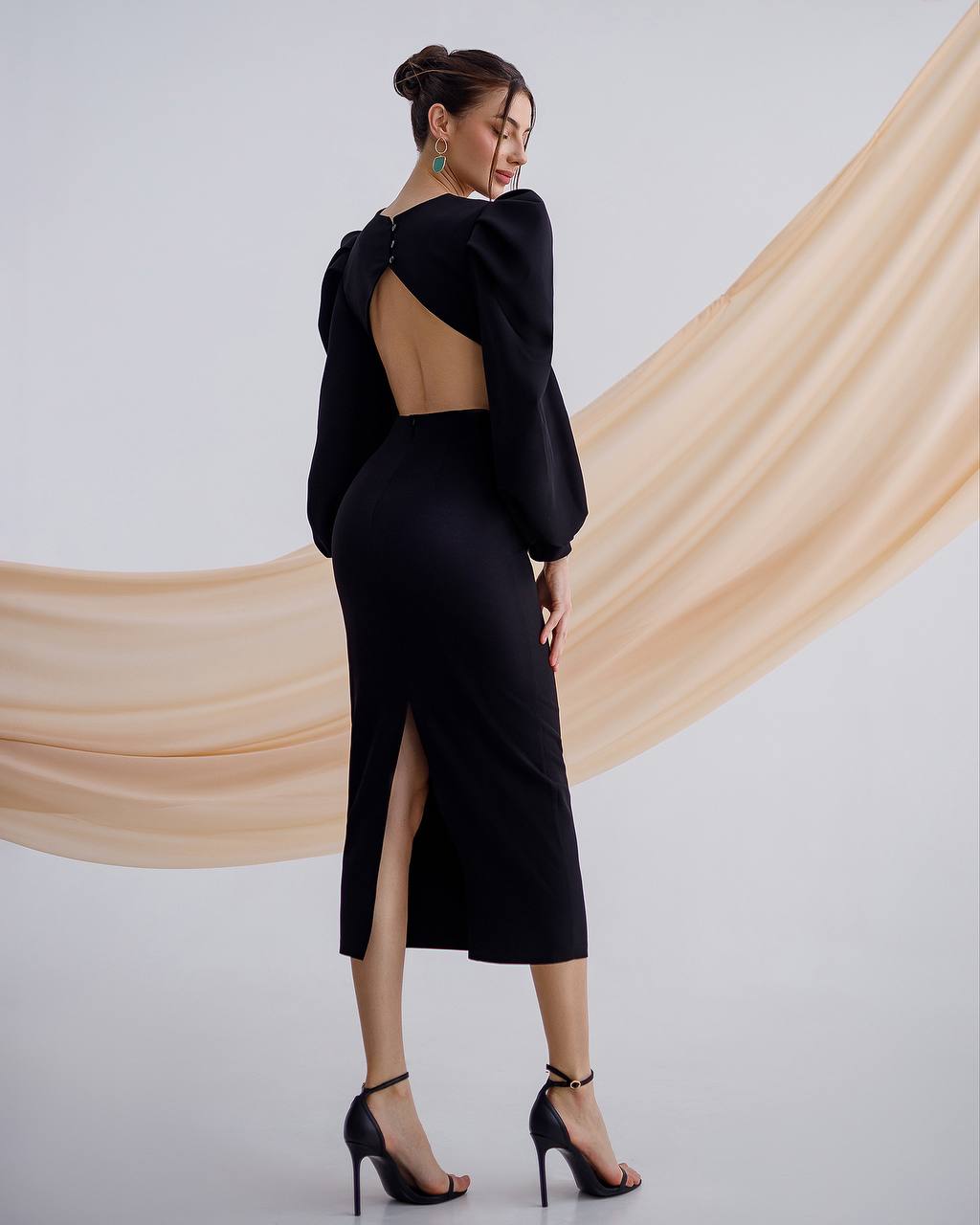 a woman in a black dress with a high slit