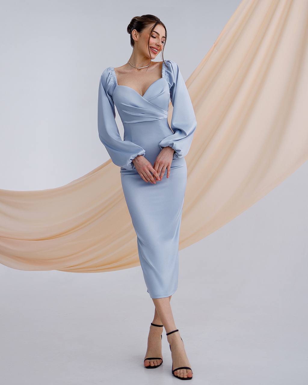 a woman in a blue dress posing for a picture