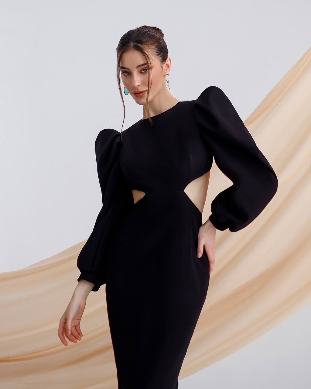 a woman in a black dress posing for a picture
