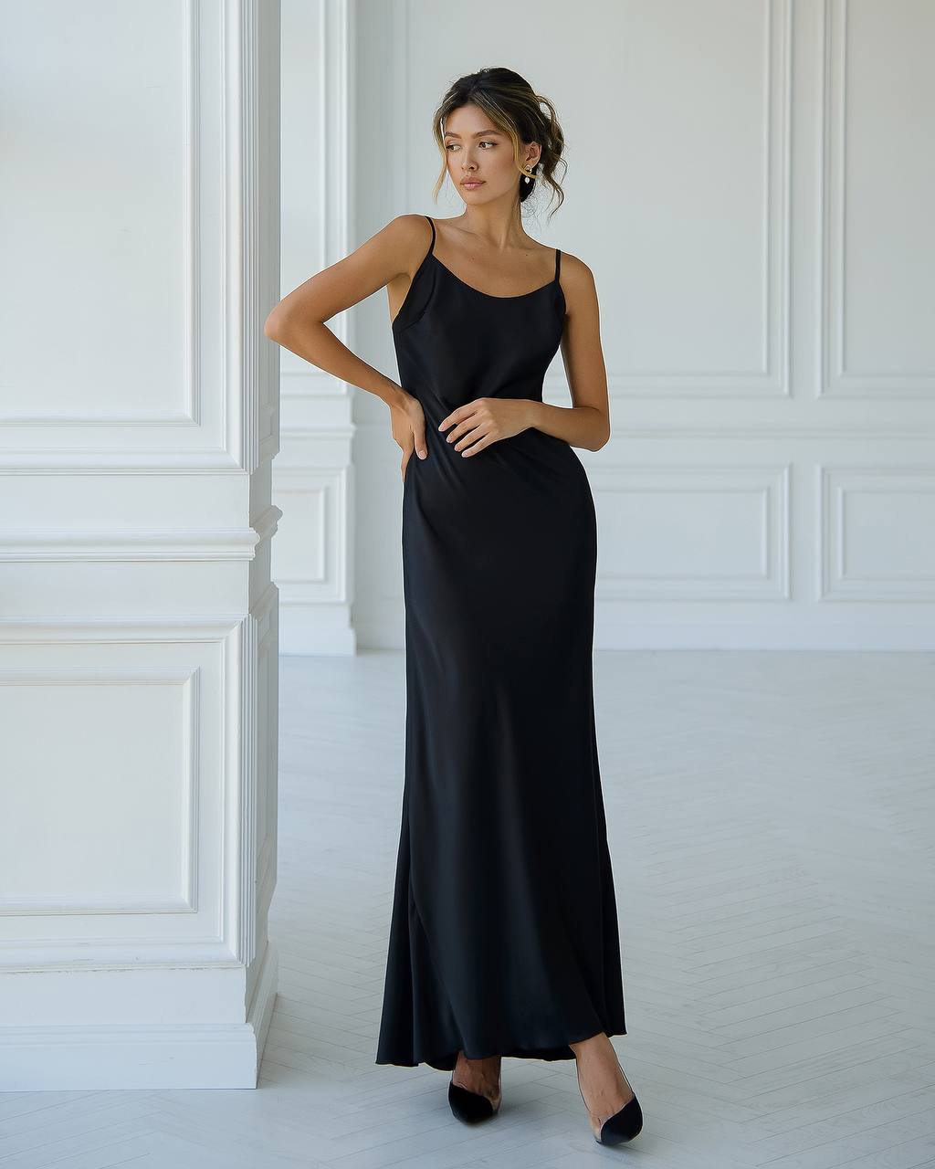 a woman in a black dress posing for a picture