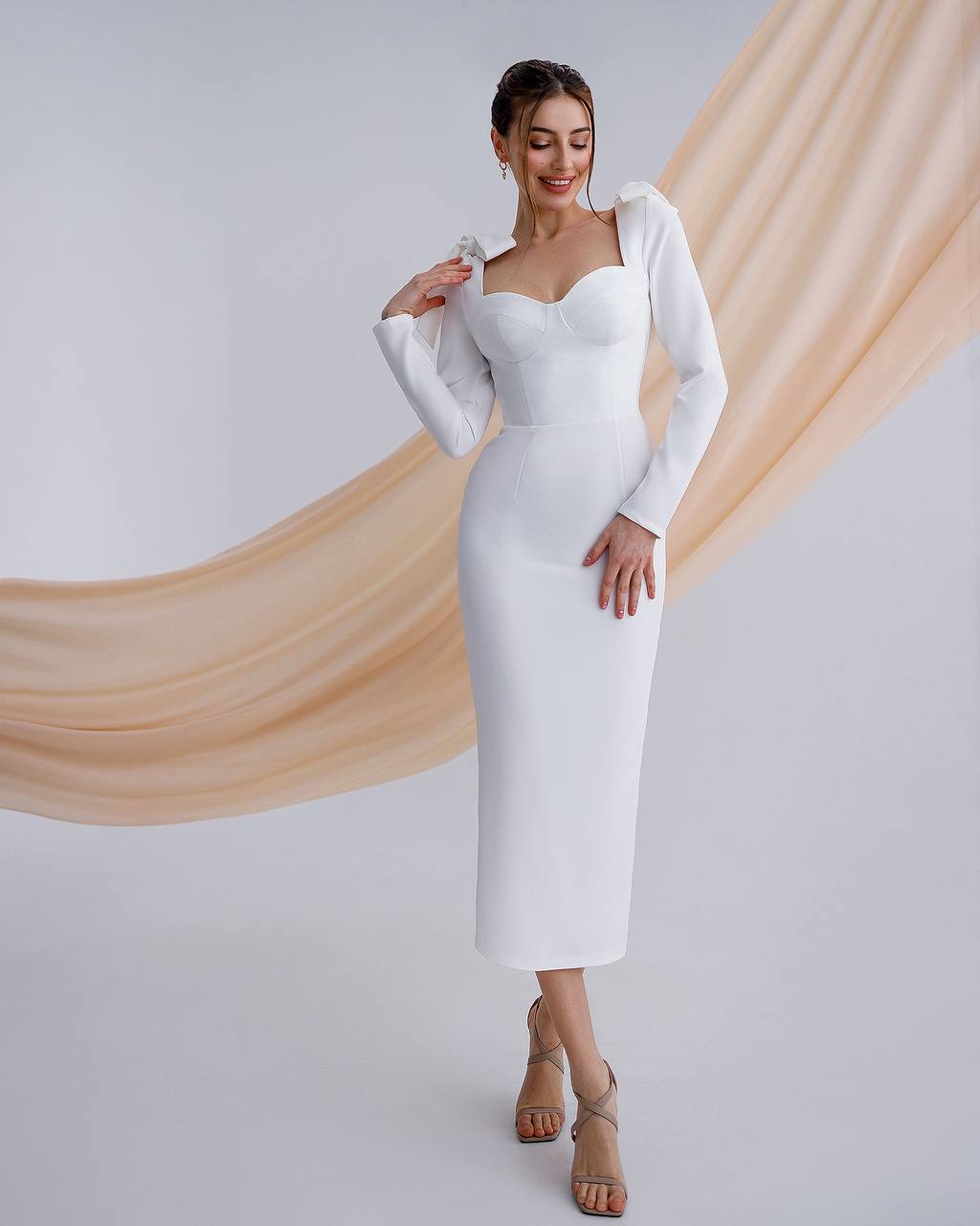 a woman in a white dress posing for a picture