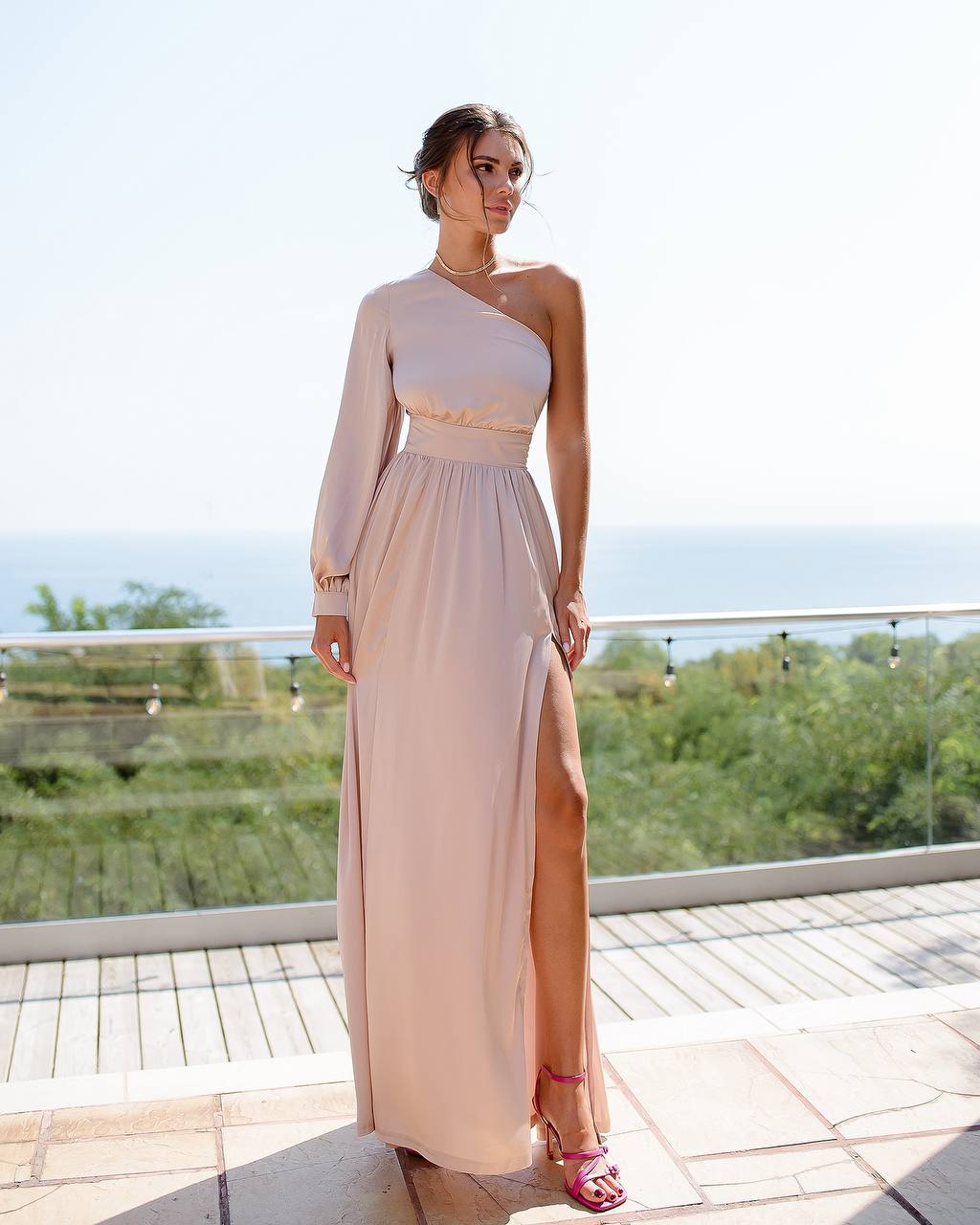 a woman in a long dress posing for a picture