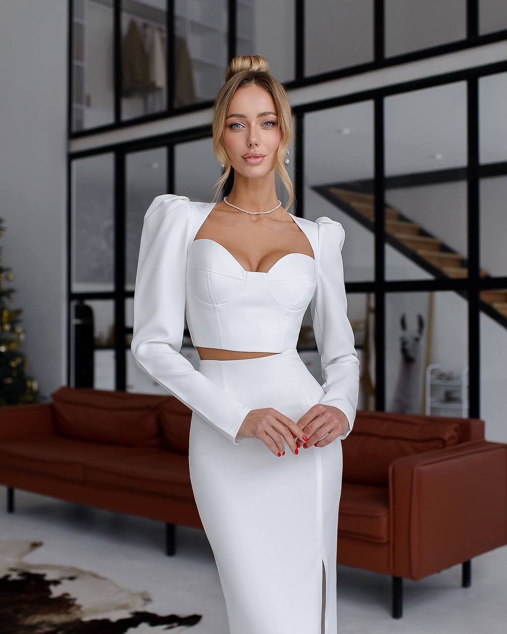 a woman in a white dress posing for a picture