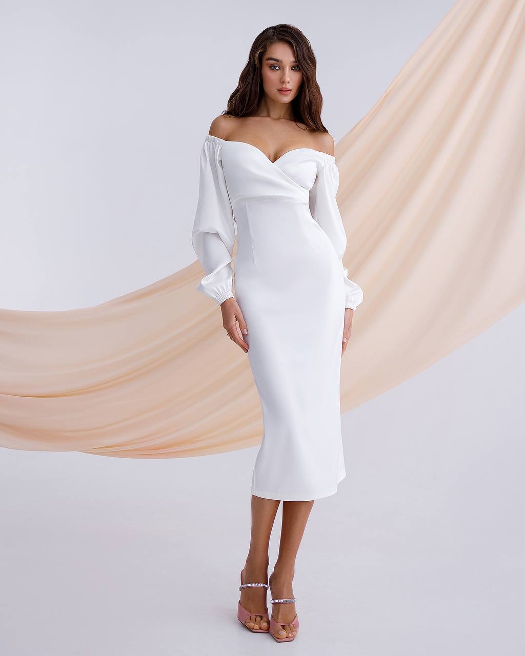 a woman in a white dress posing for a picture