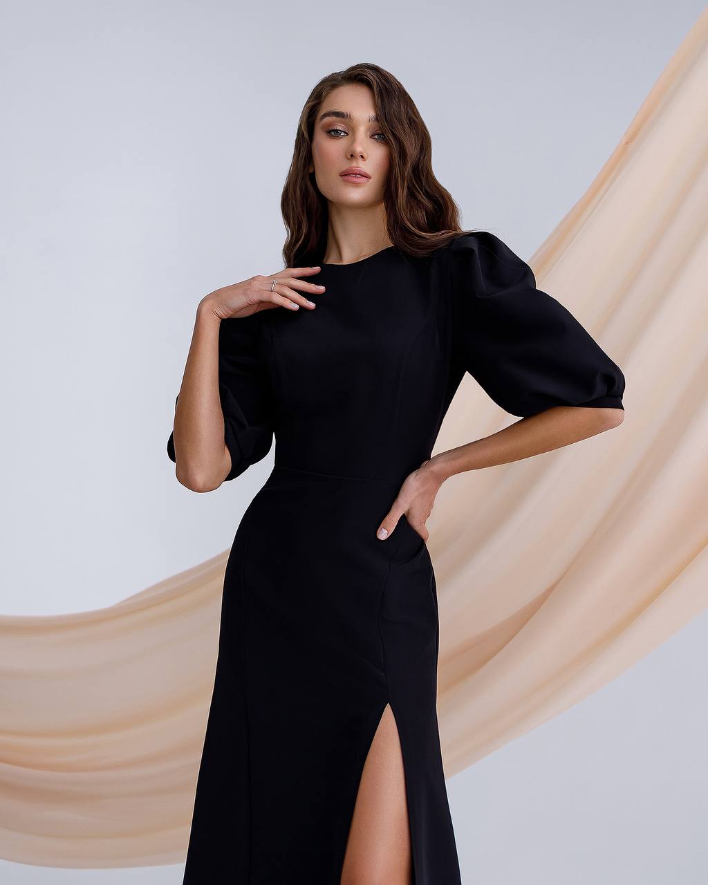 a woman in a black dress posing for a picture