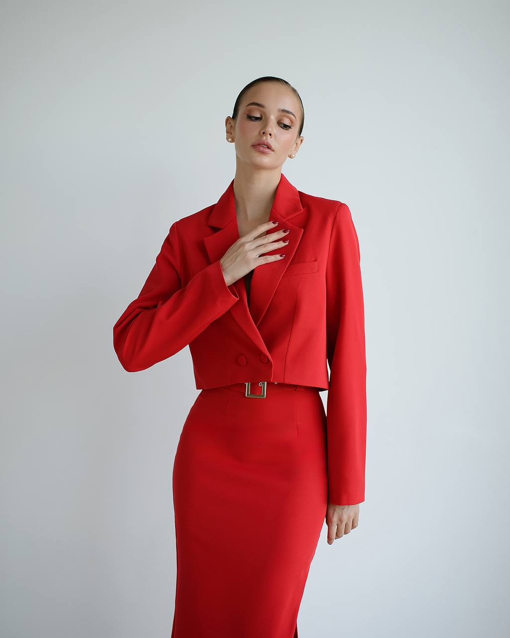 a woman in a red dress and a red jacket