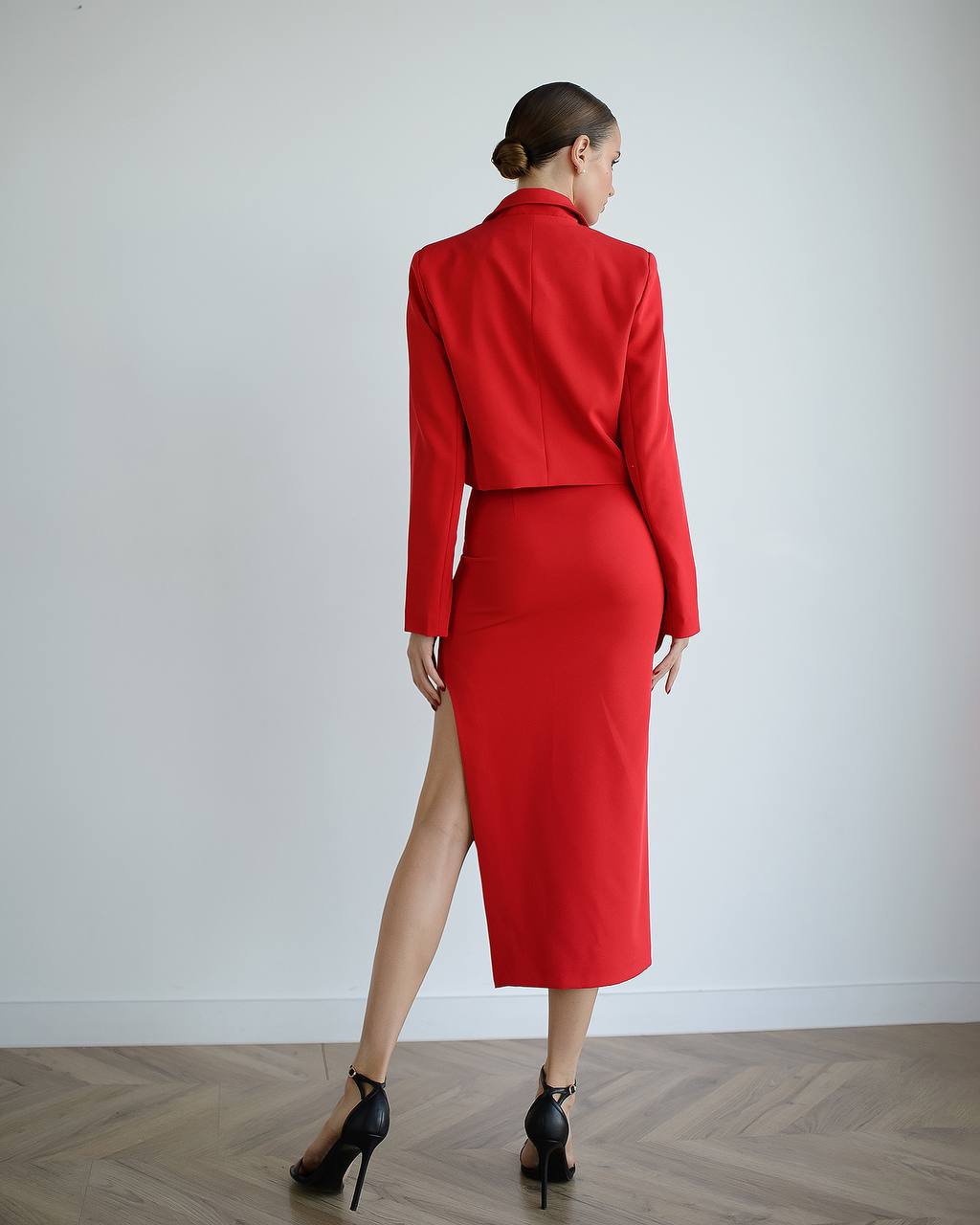 a woman in a red dress with a high slit