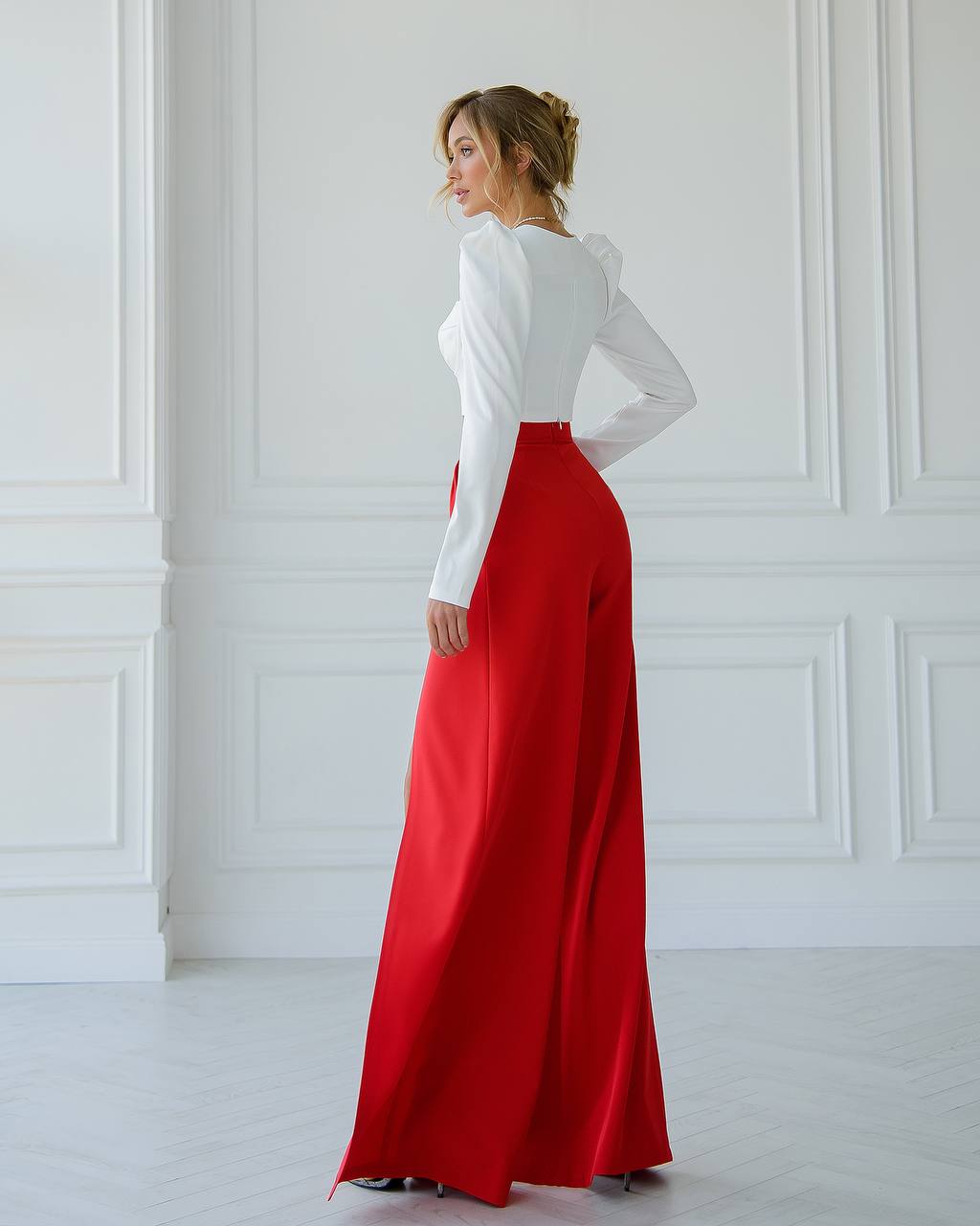 a woman in a white shirt and red skirt