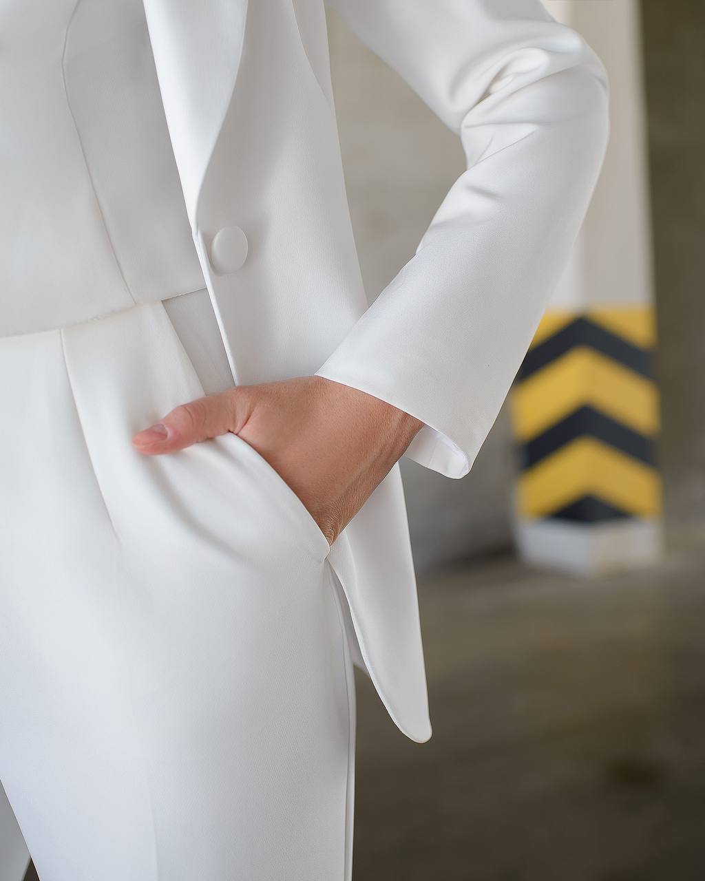 a close up of a person wearing a white suit