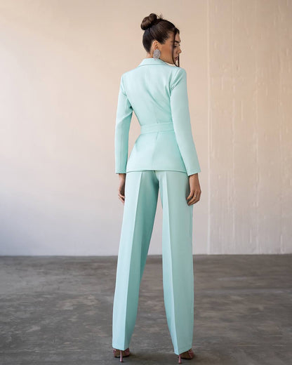 a woman in a light blue suit and heels