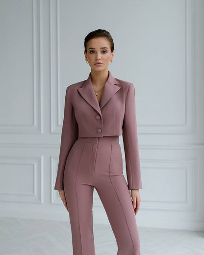 a woman wearing a pink suit and heels