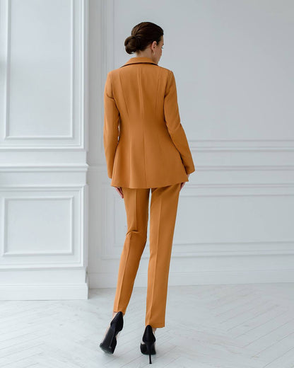 a woman in an orange suit and heels