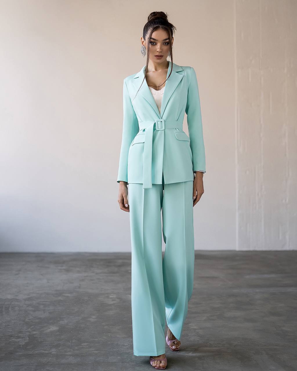 a woman in a light blue suit and sandals