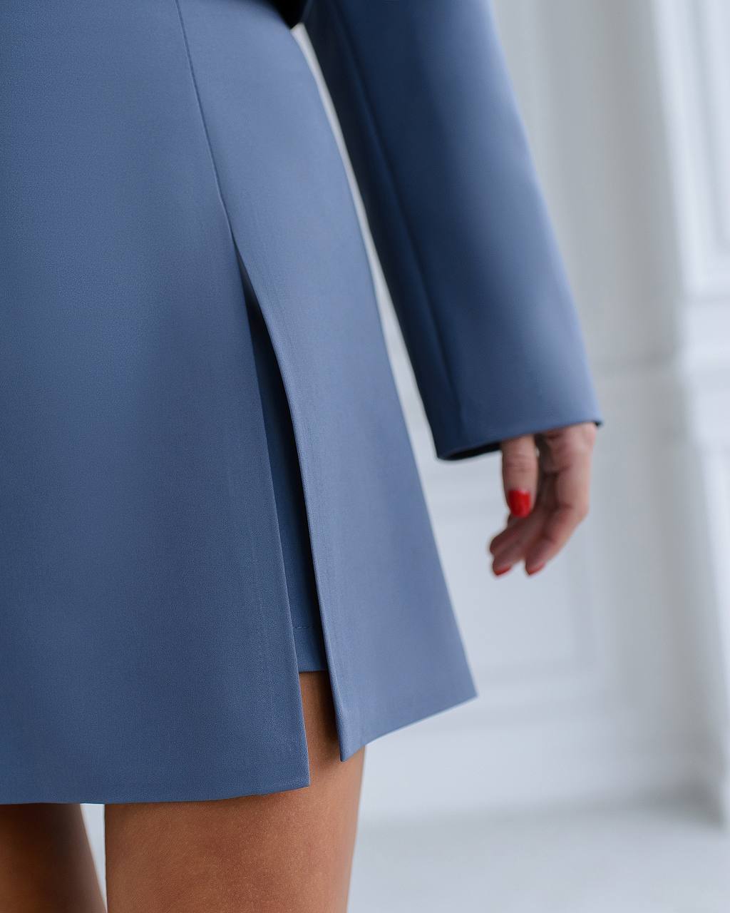 a close up of a person wearing a blue skirt
