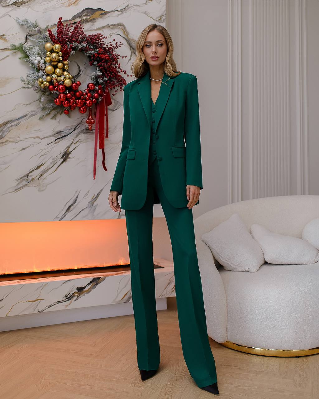 a woman in a green suit standing in a room