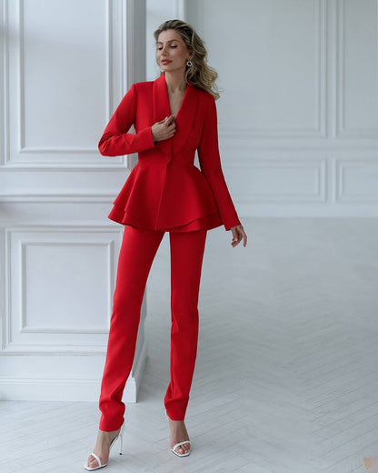 a woman in a red suit posing for a picture