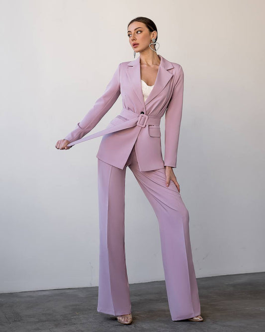 a woman in a pink suit and heels