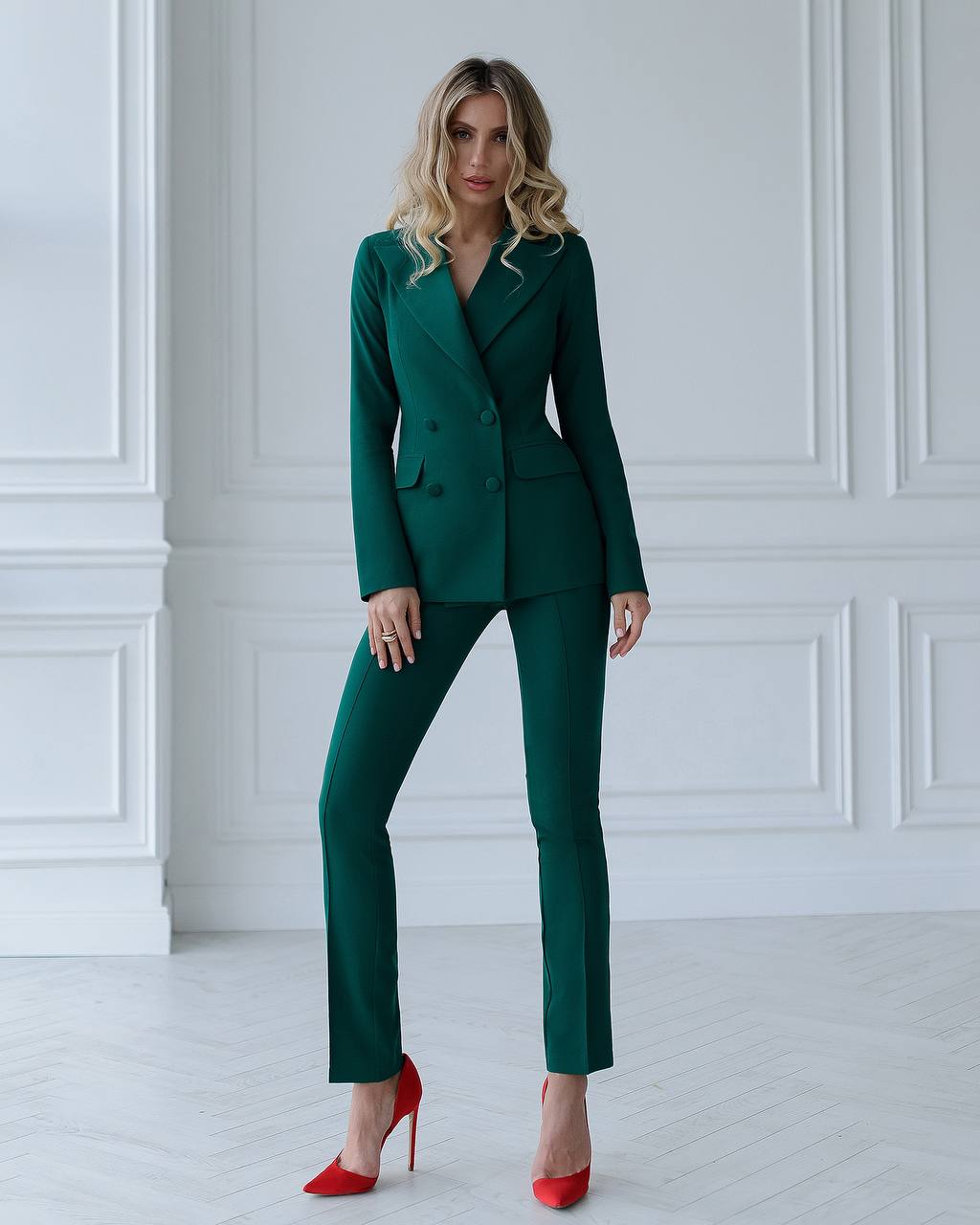 a woman in a green suit posing for a picture
