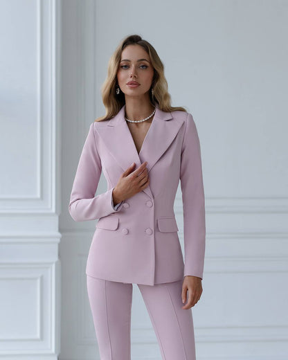 a woman in a pink suit posing for a picture