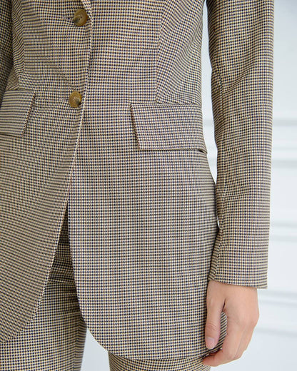a woman in a brown and white checkered suit