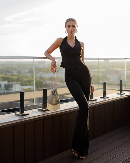 a woman posing on a balcony with a handbag