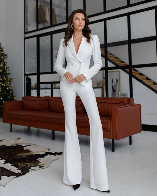 a woman in a white suit posing for a picture