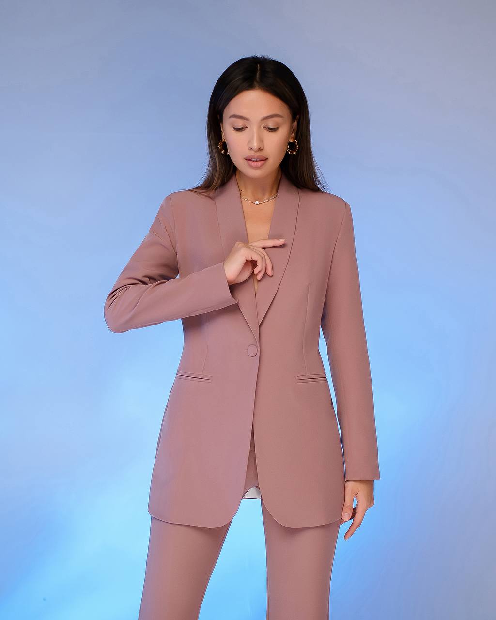 a woman in a pink suit posing for a picture