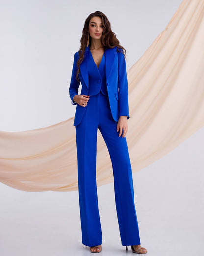 a woman in a blue suit posing for a picture