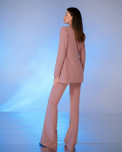 a woman in a pink suit is standing in the water