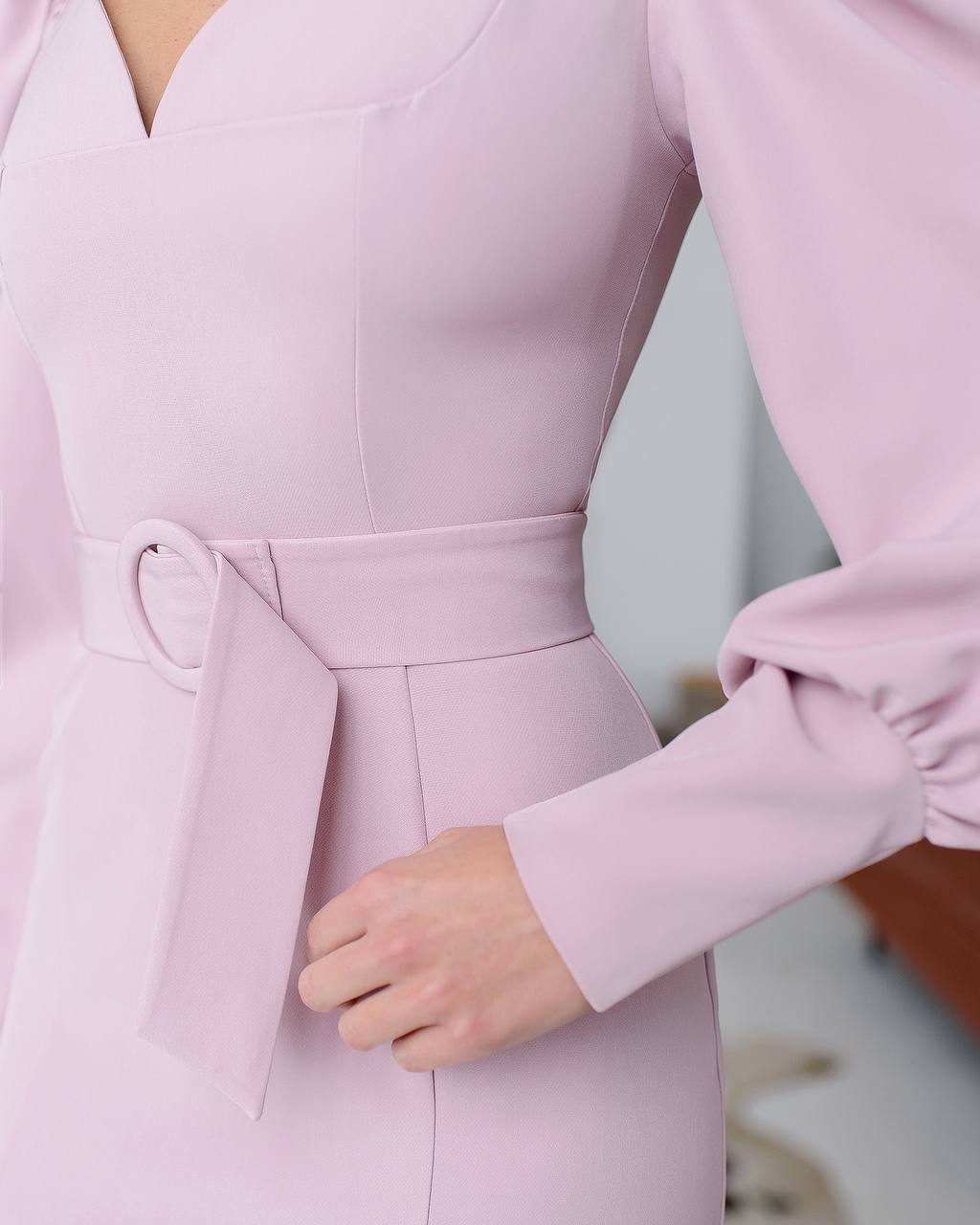a close up of a woman wearing a pink dress
