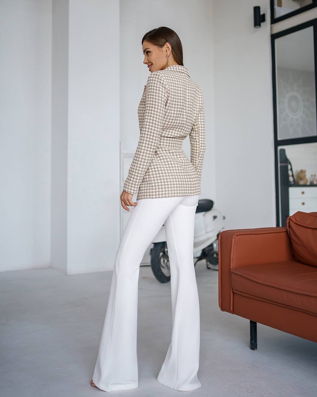 a woman in white pants and a jacket