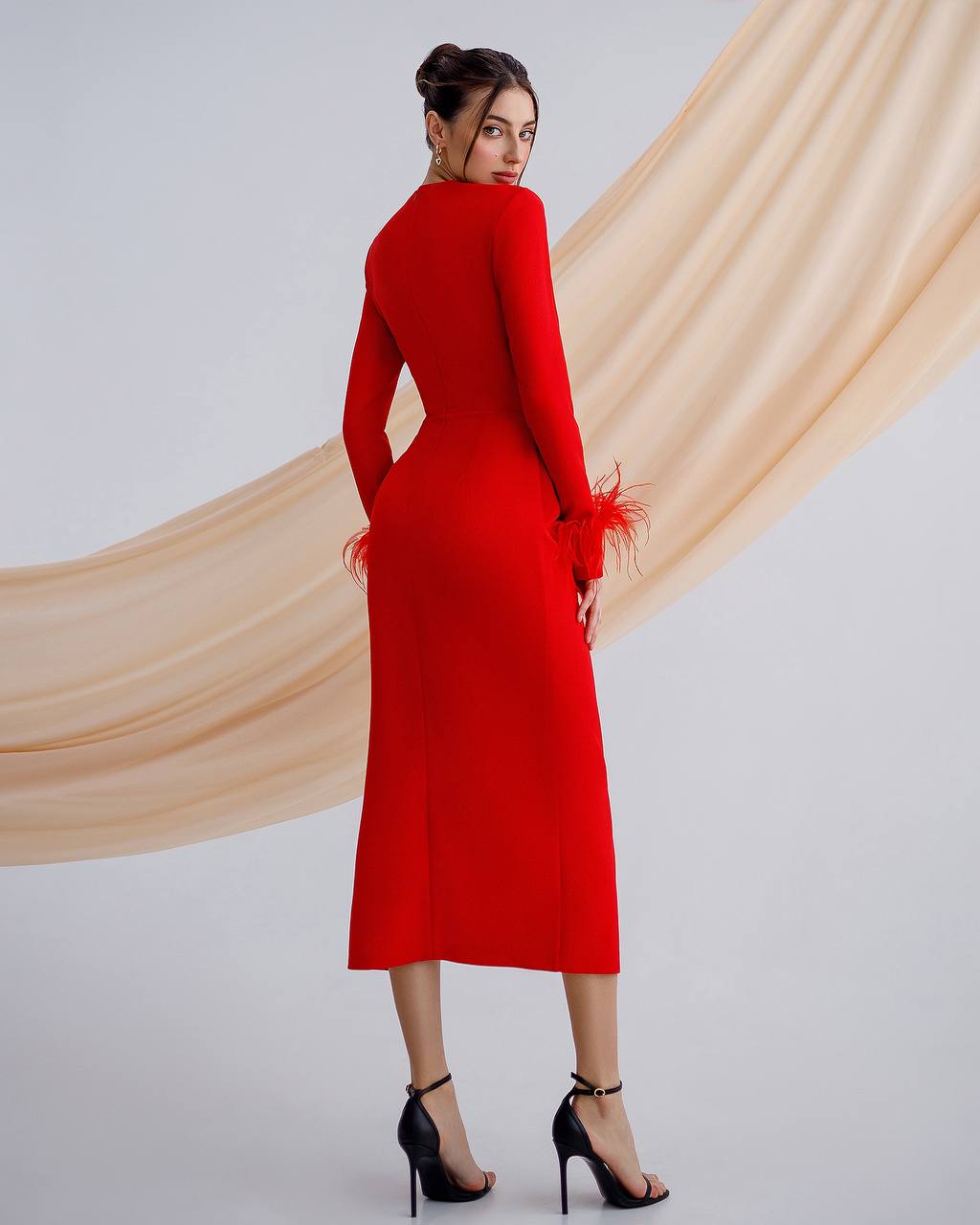 a woman in a red dress is standing with her hands on her hips