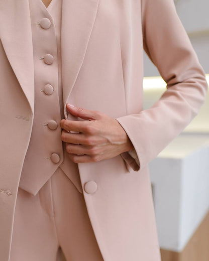 a close up of a person wearing a pink suit