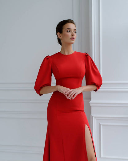 a woman in a red dress with a slit