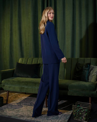 a woman standing in front of a green couch