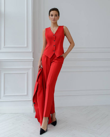 a woman in a red jumpsuit posing for a picture