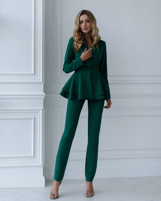 a woman wearing a green suit and matching heels