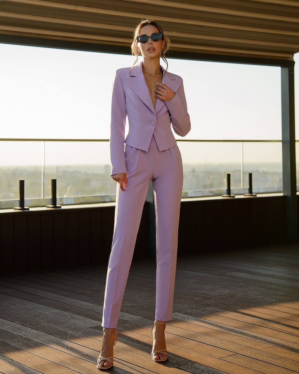 a woman in a purple suit posing for a picture