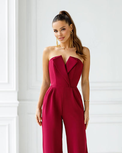 a woman wearing a red strapless jumpsuit